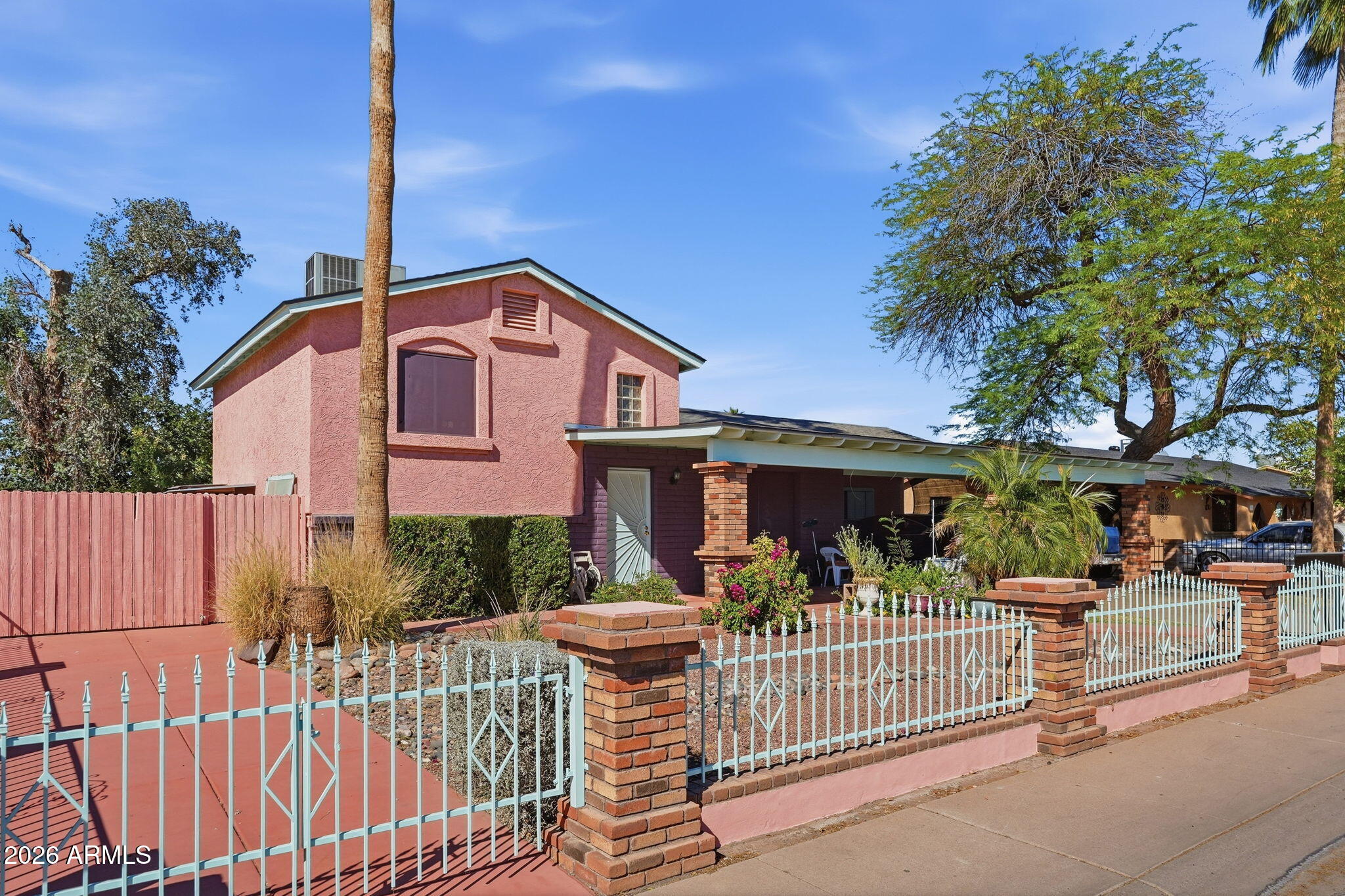 4702 East Alta Vista Road Phoenix, AZ 85042 - Photo 18 of 20 a front view of a house with a porch