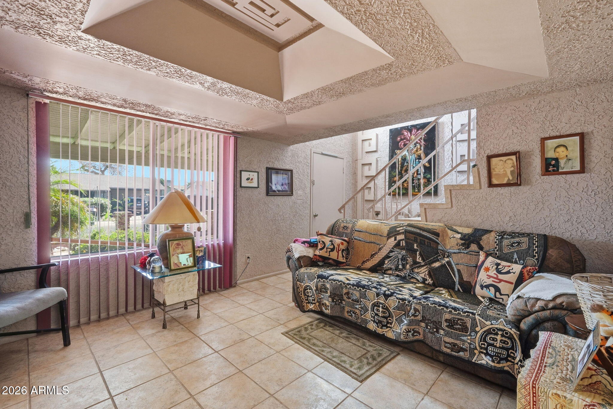 4702 East Alta Vista Road Phoenix, AZ 85042 - Photo 2 of 20 a living room with furniture and a large window