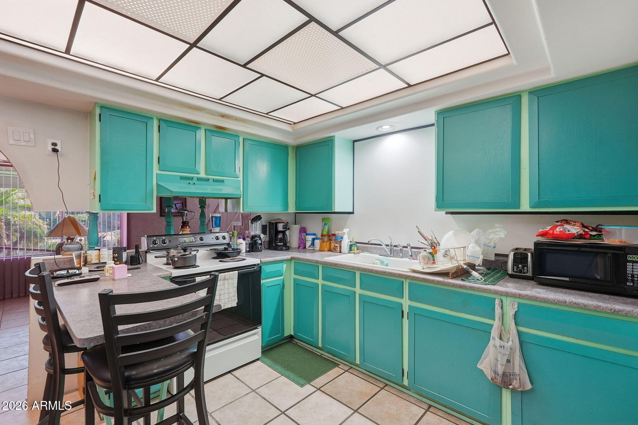 4702 East Alta Vista Road Phoenix, AZ 85042 - Photo 7 of 20 a kitchen with a sink a counter top space and appliances