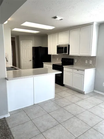 a view of a kitchen with a sink and a window