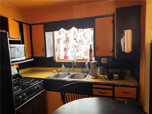 a room with furniture pool table and window