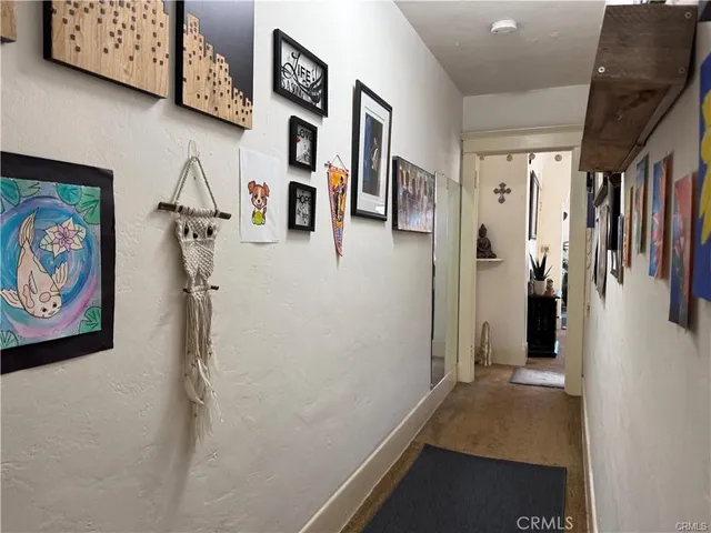 a view of a hallway with painting on wall