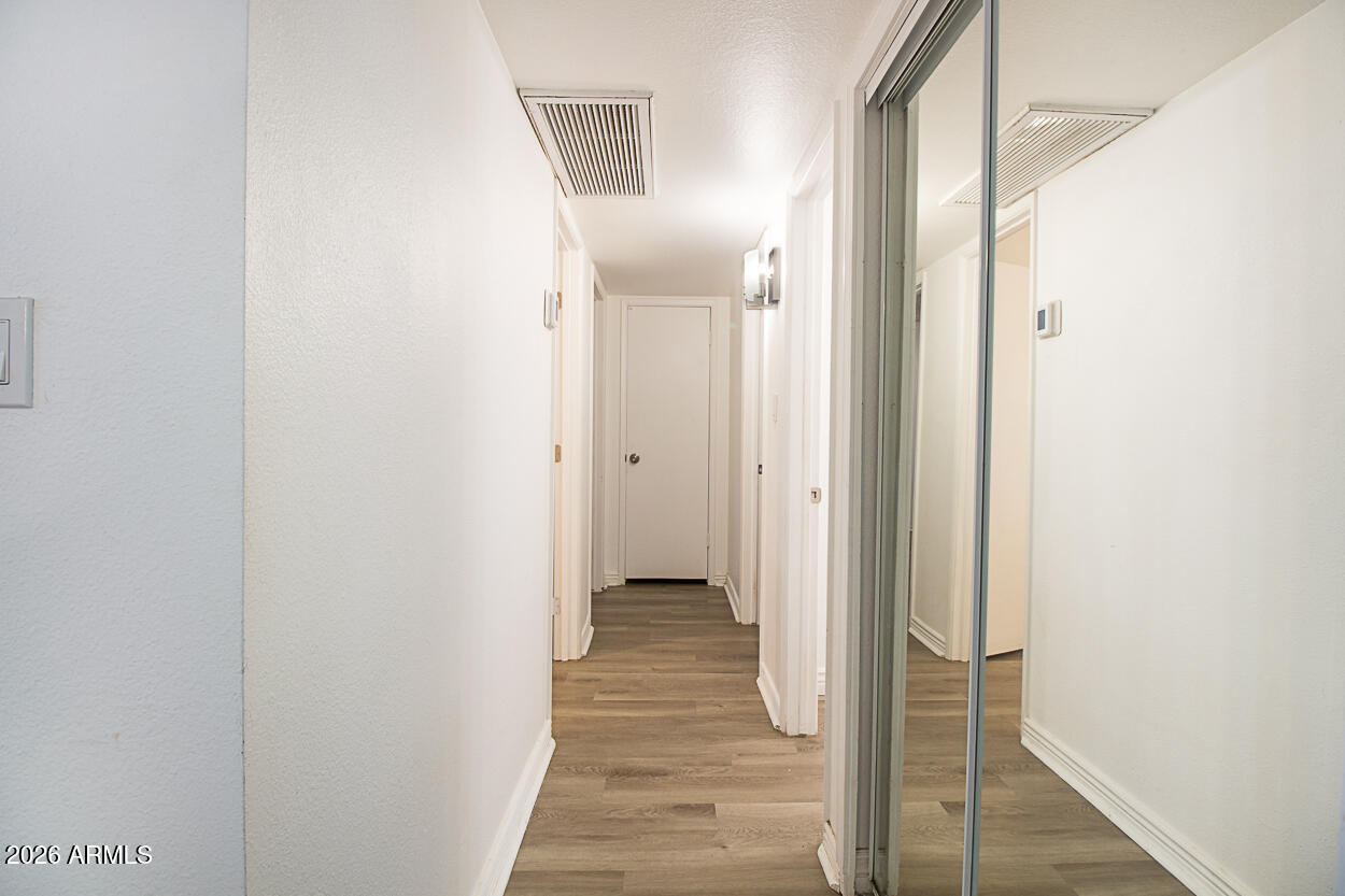 555 North May, Unit 3 Mesa, AZ 85201 - Photo 13 of 26 a view of a hallway with wooden floor