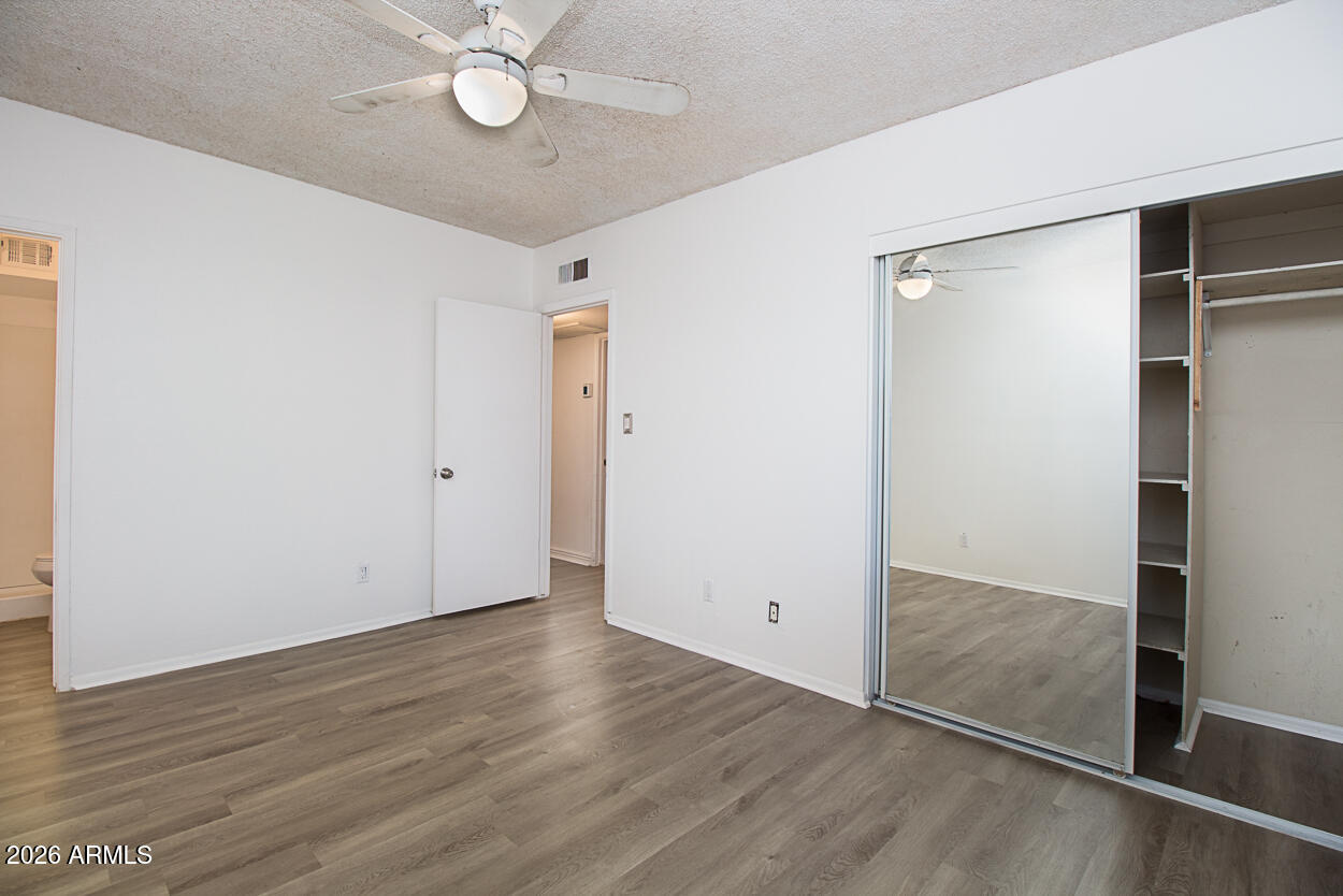 555 North May, Unit 3 Mesa, AZ 85201 - Photo 21 of 26 a view of an empty room with wooden floor