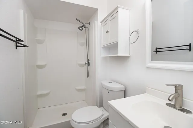 a white toilet sitting next to a bathroom sink