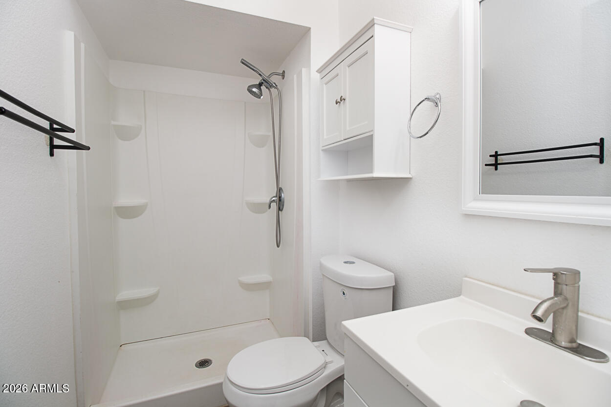 555 North May, Unit 3 Mesa, AZ 85201 - Photo 22 of 26 a white toilet sitting next to a bathroom sink