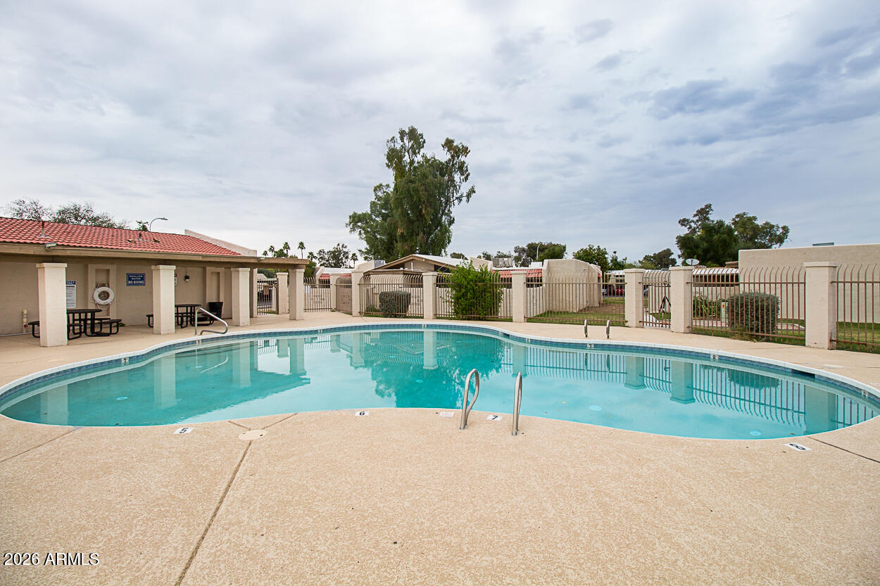 555 North May, Unit 3 Mesa, AZ 85201 - Photo 25 of 26 a front view of house with yard and swimming pool