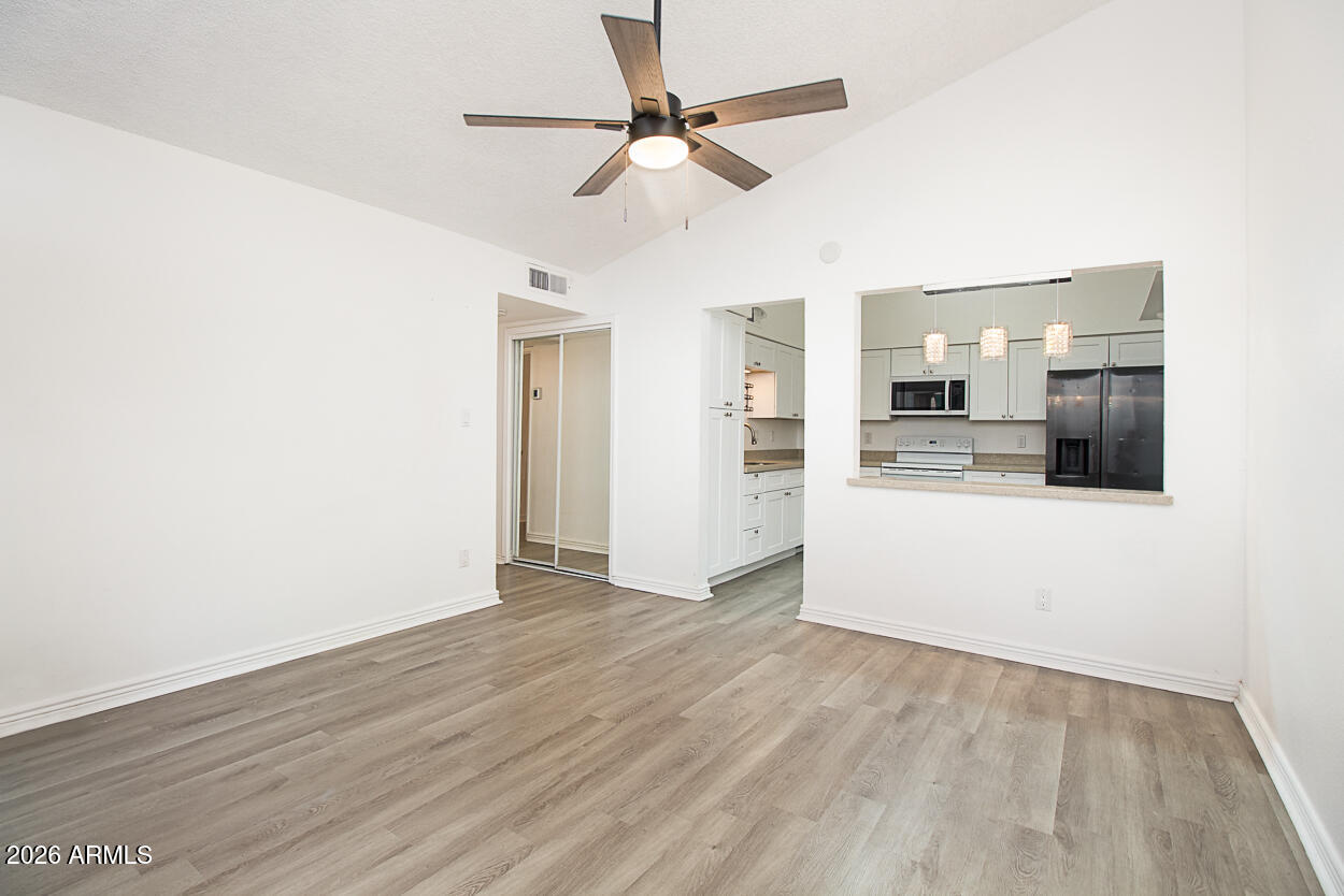 555 North May, Unit 3 Mesa, AZ 85201 - Photo 6 of 26 a view of a kitchen with a sink and a refrigerator