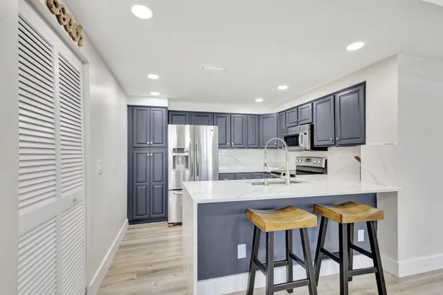 a kitchen with a sink a stove and cabinets