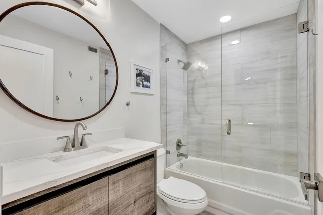 a view of a dining room with furniture and potted plants