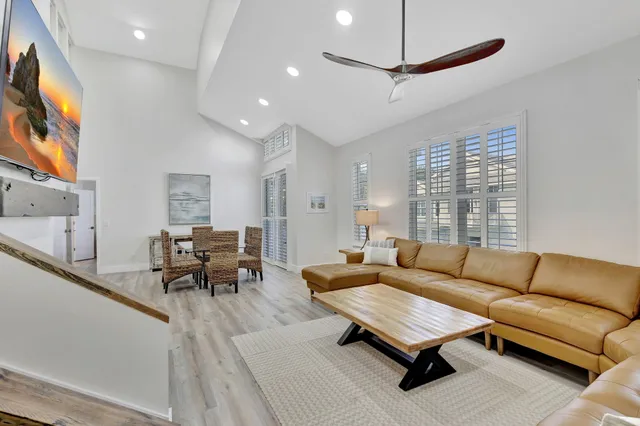 a living room with furniture and kitchen view