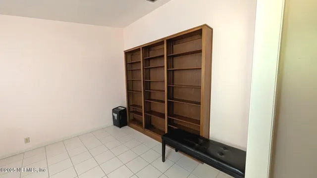 a view of walk in closet with clothes