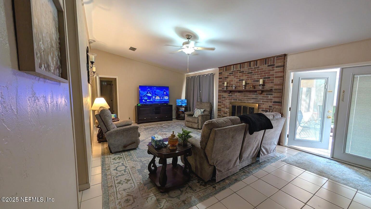 137 Tallow Road Pomona Park, FL 32181 - Photo 19 of 47 a living room with furniture a fireplace and a flat screen tv