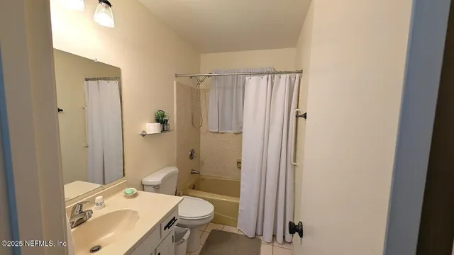 a view of a room with window and ceiling fan