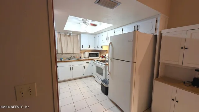a kitchen with a sink a cabinets and window