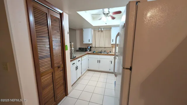 a kitchen with a sink appliances and cabinets