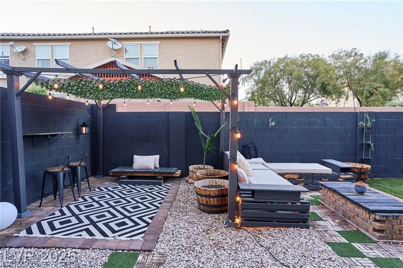 6302 Jackson Spring Road Las Vegas, NV 89118 - Photo 22 of 23 An inviting backyard retreat offers diverse seating options and ample space for relaxation.