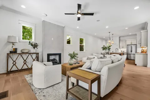 a living room with furniture a fireplace and a table
