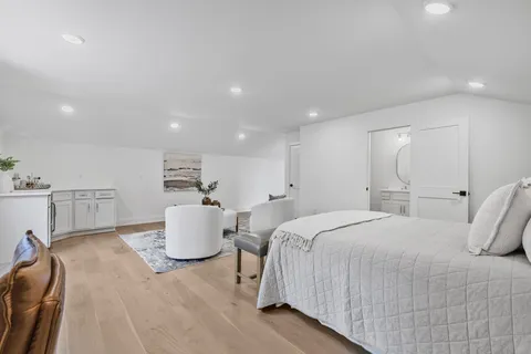 a bedroom with a bed and a couch