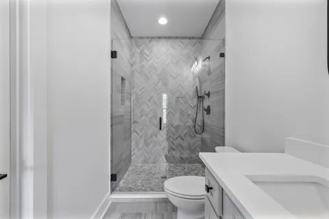 a bathroom with a shower a toilet and a sink