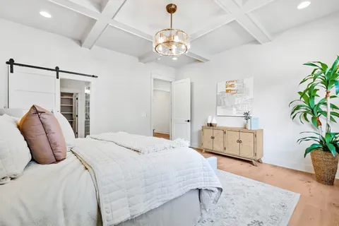 a spacious bedroom with a bed and a dresser