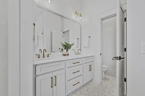 a bathroom with a double vanity sink and mirror