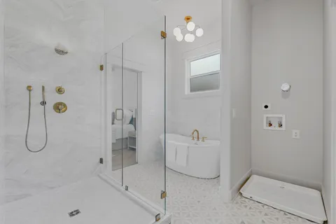 a bathroom with a granite countertop shower a mirror and vanity