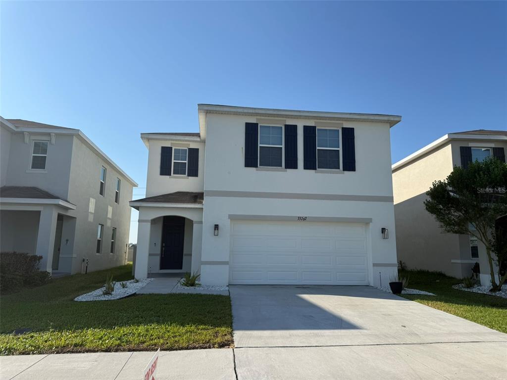 33762 Jasmine Star Loop Wesley Chapel, FL 33543 - Photo 1 of 27 a view of a house with a yard