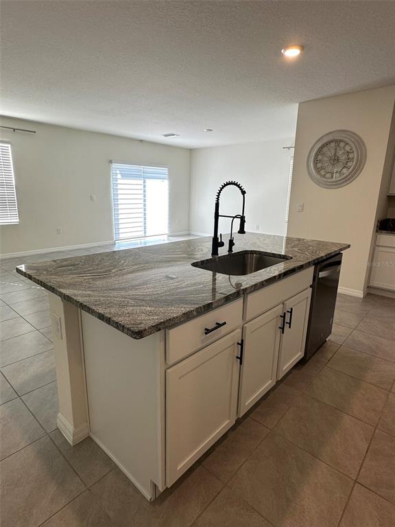 33762 Jasmine Star Loop Wesley Chapel, FL 33543 - Photo 12 of 27 a kitchen with stainless steel appliances granite countertop a sink and white cabinets