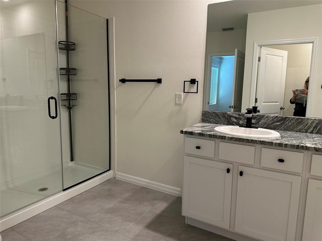 33762 Jasmine Star Loop Wesley Chapel, FL 33543 - Photo 16 of 27 a bathroom with a double vanity sink mirror and shower