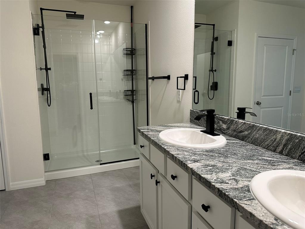 33762 Jasmine Star Loop Wesley Chapel, FL 33543 - Photo 17 of 27 a bathroom with a granite countertop sink and a mirror