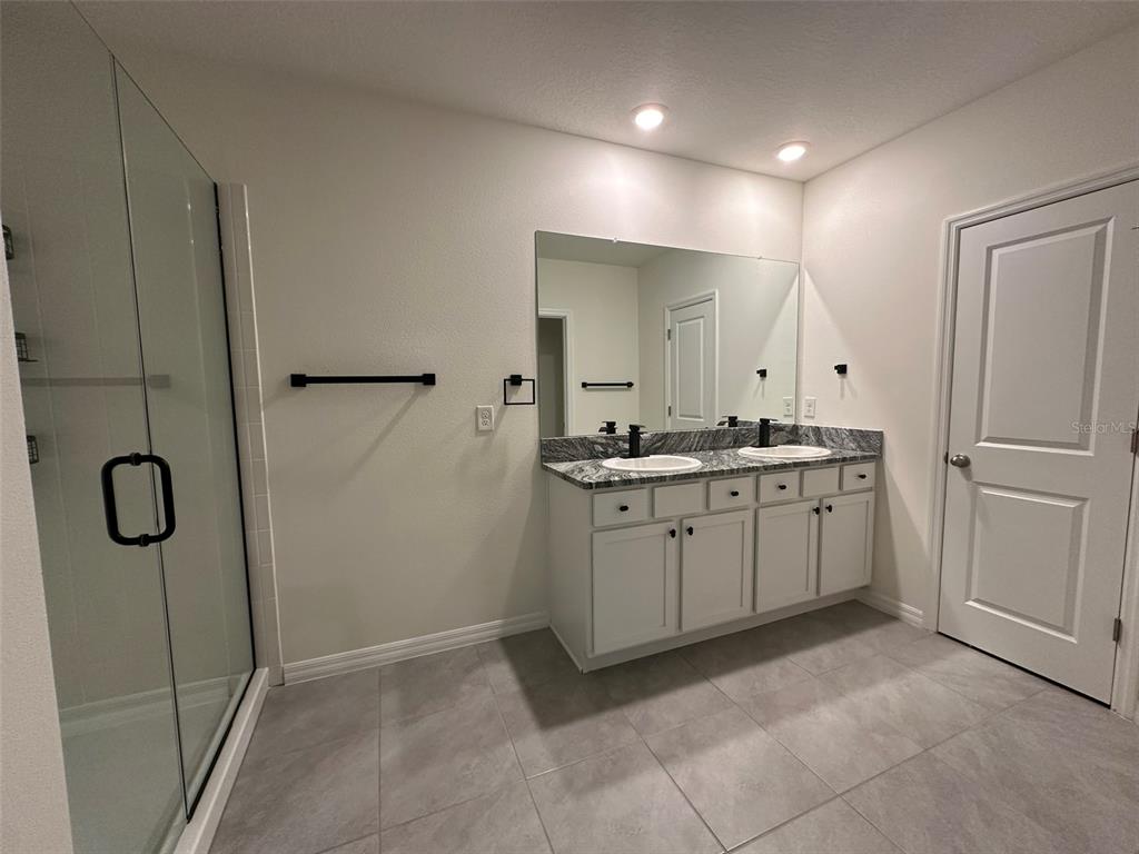 33762 Jasmine Star Loop Wesley Chapel, FL 33543 - Photo 19 of 27 a kitchen with a refrigerator and white cabinets