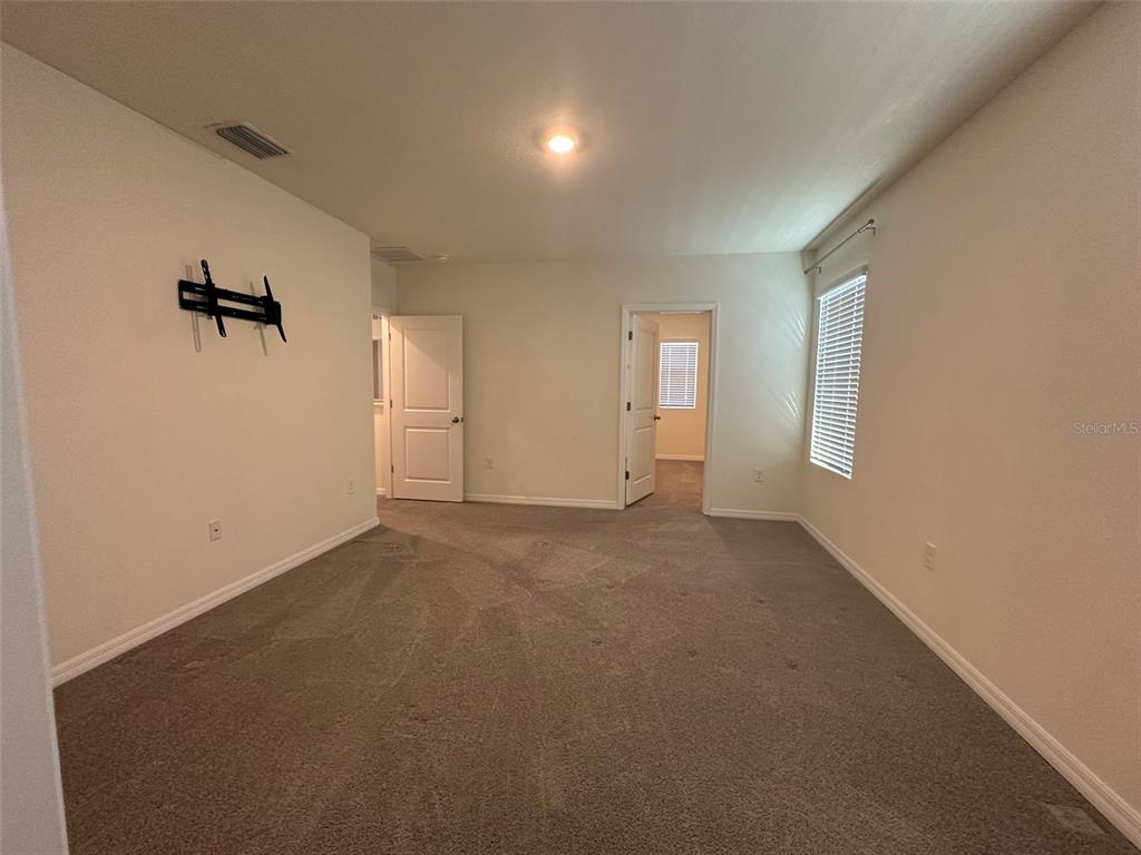 33762 Jasmine Star Loop Wesley Chapel, FL 33543 - Photo 21 of 27 a view of empty room with windows