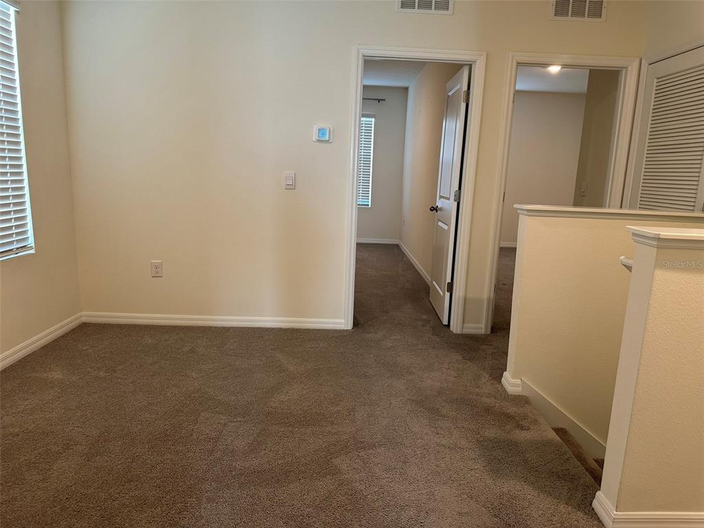 33762 Jasmine Star Loop Wesley Chapel, FL 33543 - Photo 22 of 27 an empty room with a door