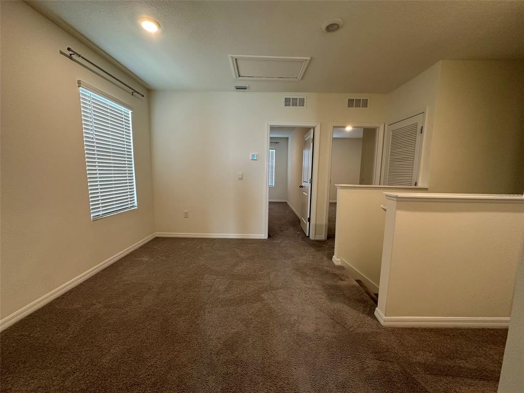 33762 Jasmine Star Loop Wesley Chapel, FL 33543 - Photo 23 of 27 a view of a hallway with a kitchen