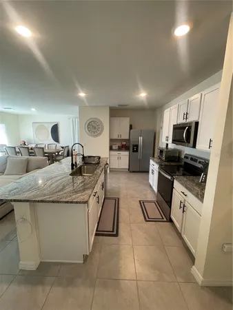 a kitchen with granite countertop a sink and counter top space
