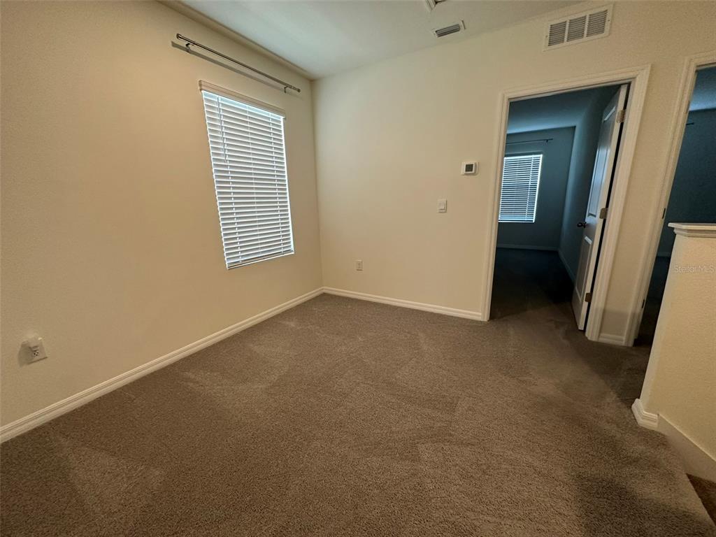 33762 Jasmine Star Loop Wesley Chapel, FL 33543 - Photo 10 of 27 a view of an empty room with a window