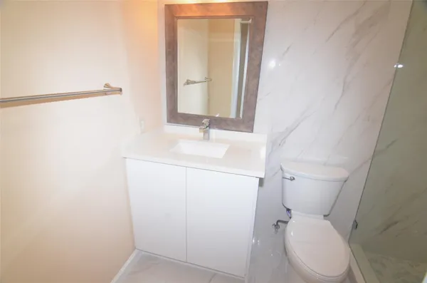a white toilet sitting next to a bathroom sink