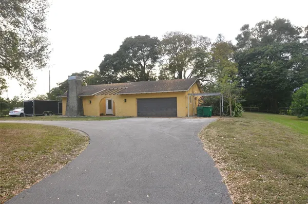 a front view of house with yard and trees