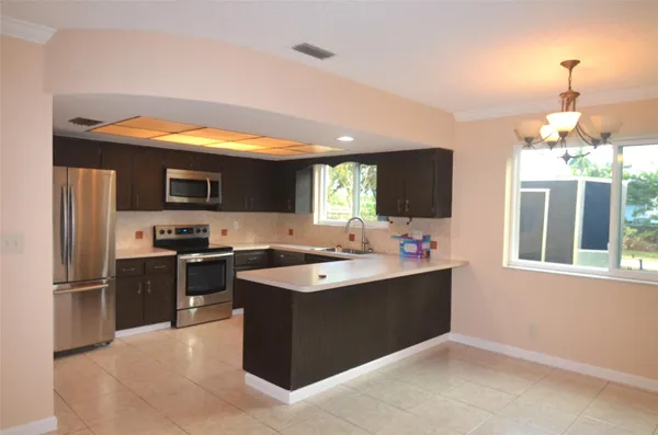a view of a kitchen with a sink and microwave