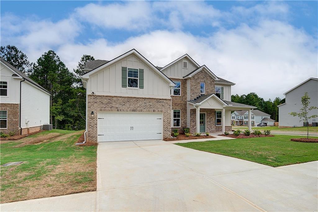 270 Linford Drive Locust Grove, GA 30248 - Photo 3 of 45 a front view of a house with a yard and garage