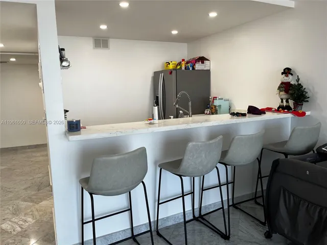 a dining room with furniture and a mirror