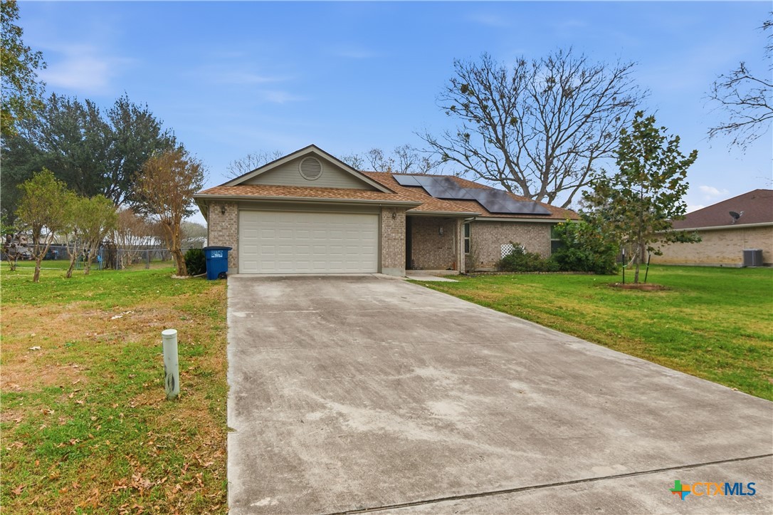 a front view of a house with yard and green space