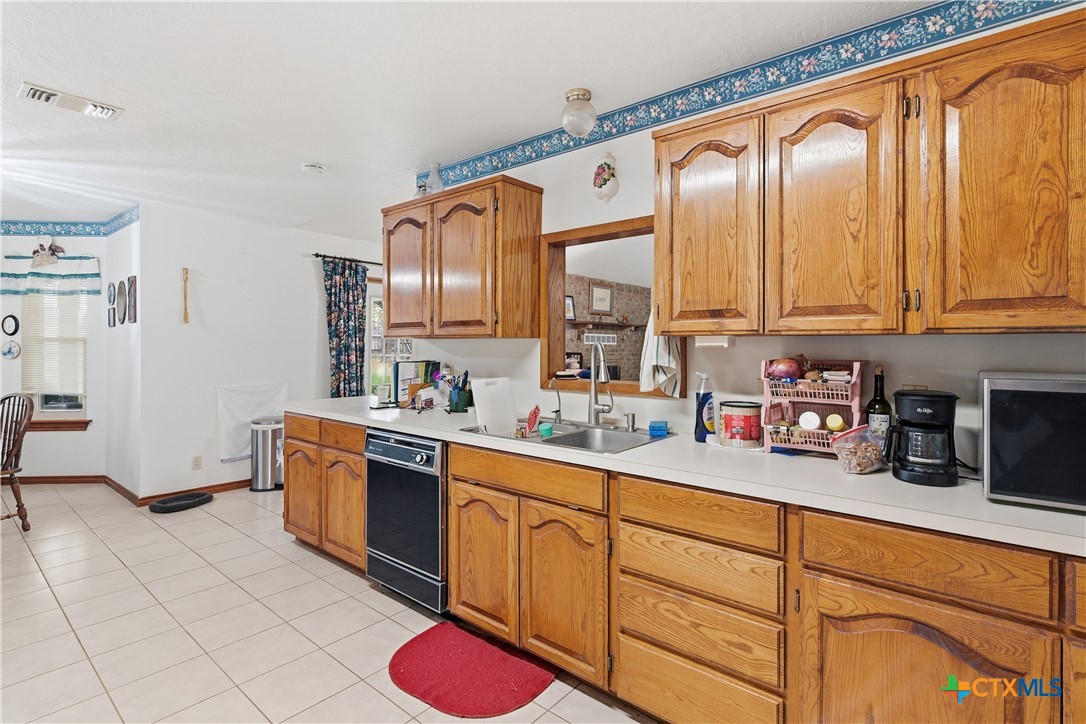 127 Santa Fe Ridge Seguin, TX 78155 - Photo 15 of 31 a kitchen with stainless steel appliances granite countertop a sink dishwasher stove and cabinets with wooden floor