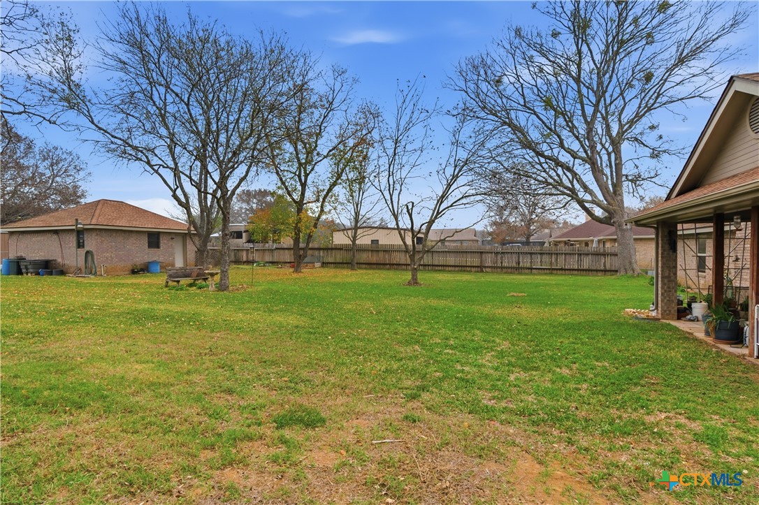 127 Santa Fe Ridge Seguin, TX 78155 - Photo 20 of 31 a view of a brick house with a big yard and large trees