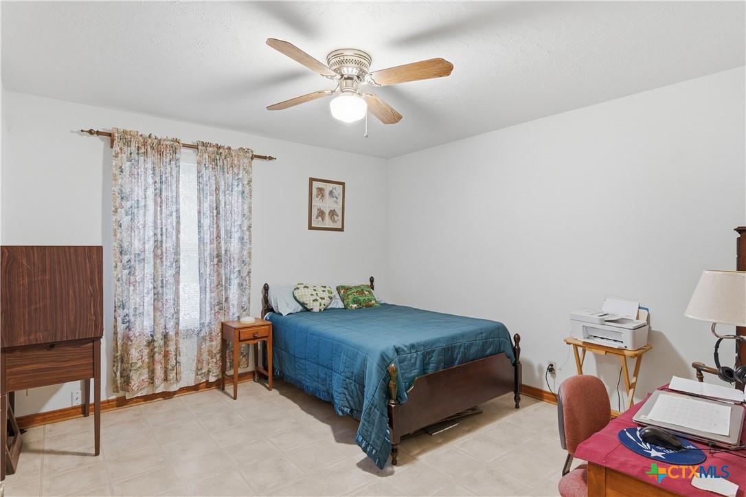 127 Santa Fe Ridge Seguin, TX 78155 - Photo 9 of 31 a bedroom with a bed and a chandelier