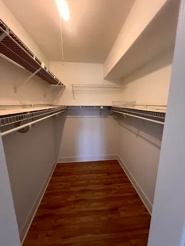 a view of a room with wooden floor