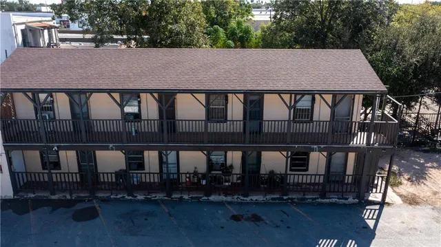 aerial view of a house with backyard and sitting area