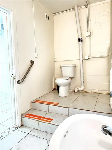 a spacious bathroom with a bathtub and toilet