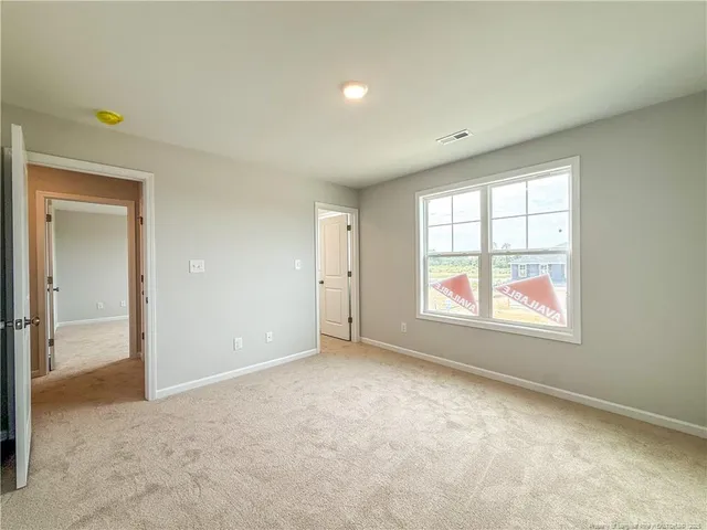 a view of a livingroom with an empty space and a hallway